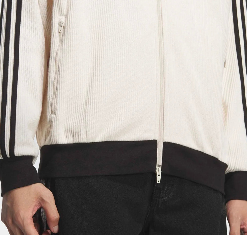 Adidas track jacket zipper front with black hem and ribbed cuffs; white knit body.