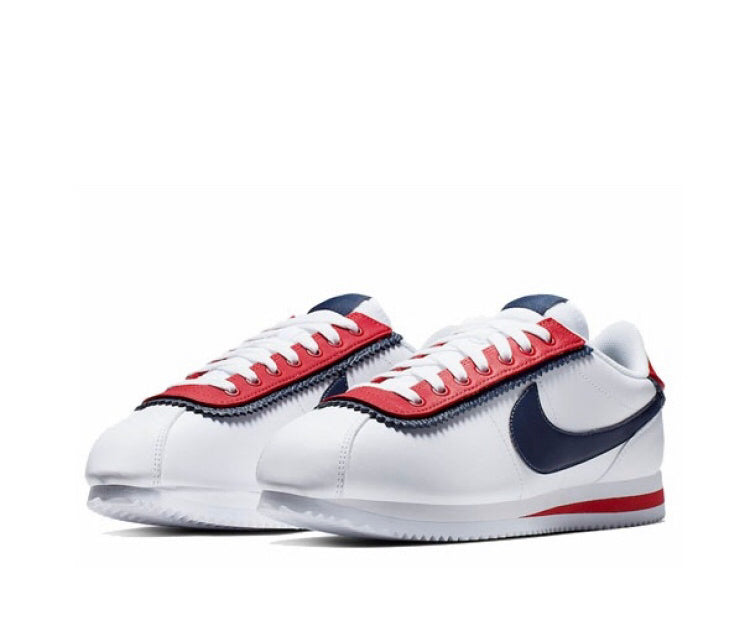 Nike Cortez low-top sneakers in white with red laces and navy Swoosh accents