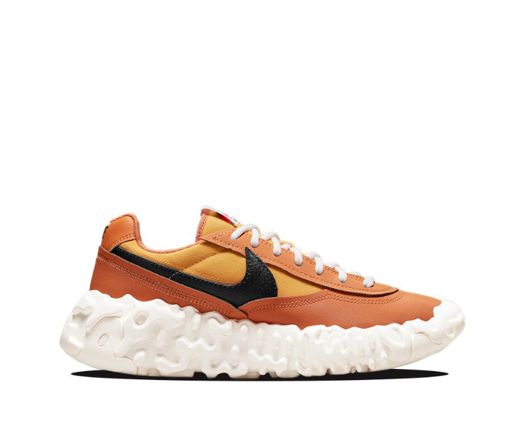 Orange low-top sneakers with black swoosh and yellow underlay, white textured sole.