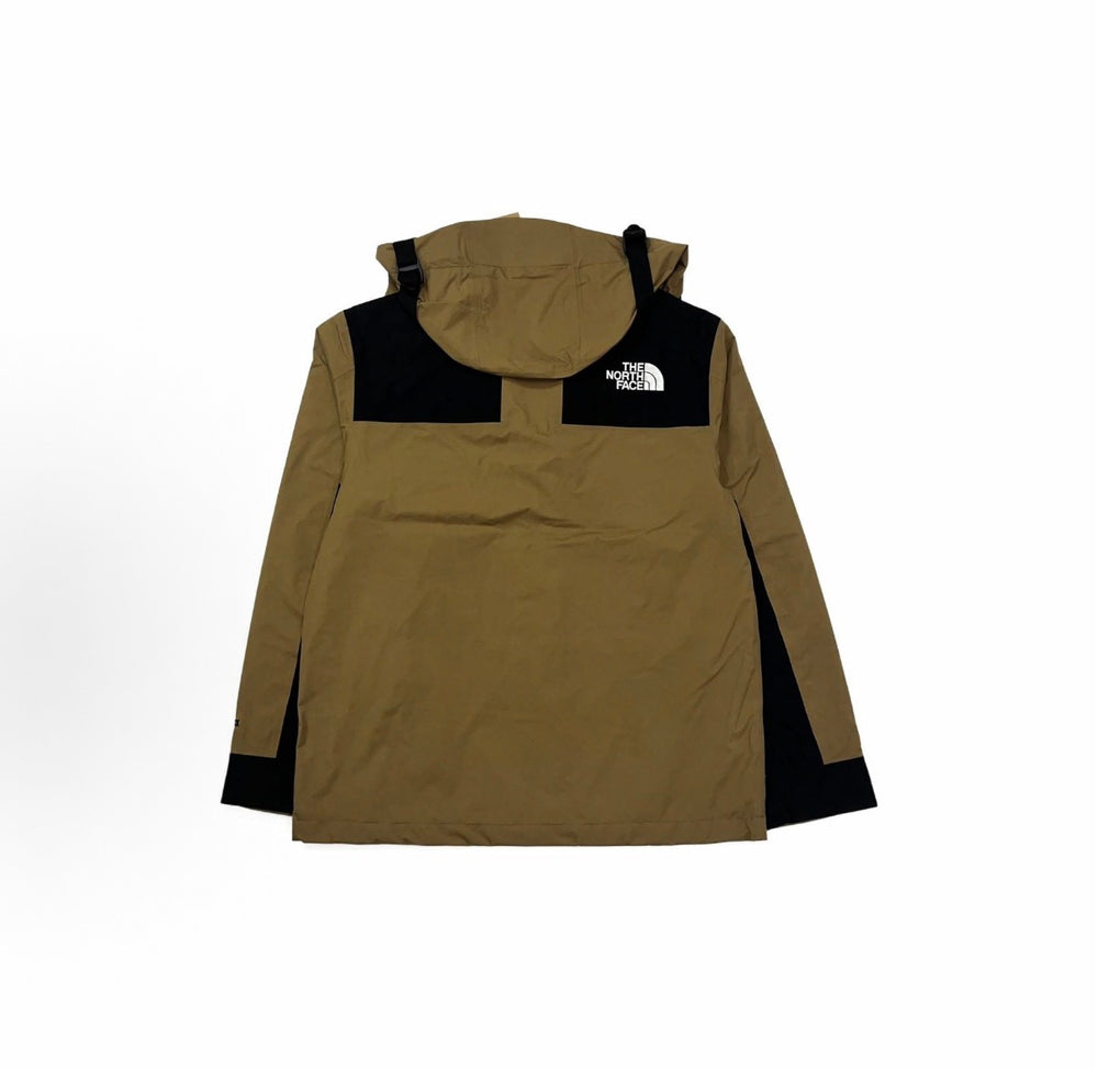Tan hooded windbreaker jacket with black chest panels and snap pocket flaps