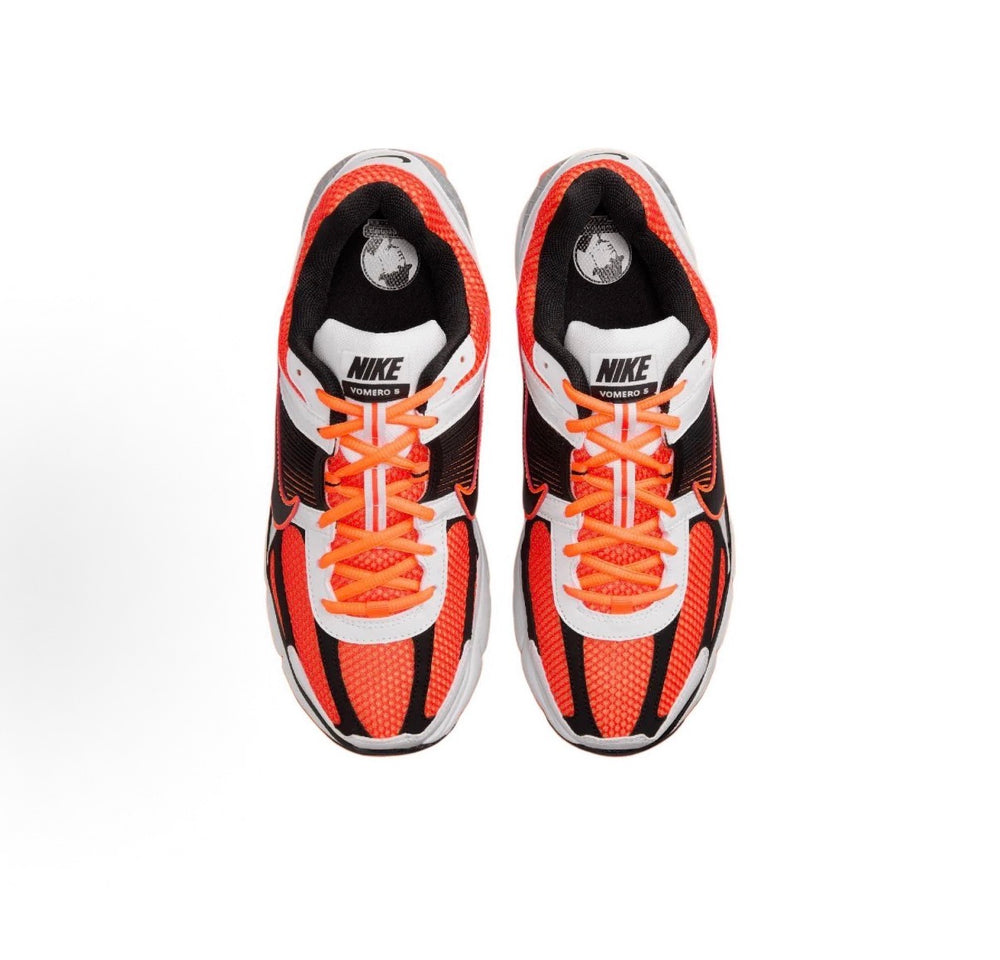 Nike Zoom Vomero 5 SP running shoes with orange laces, black mesh, and white toe cap.