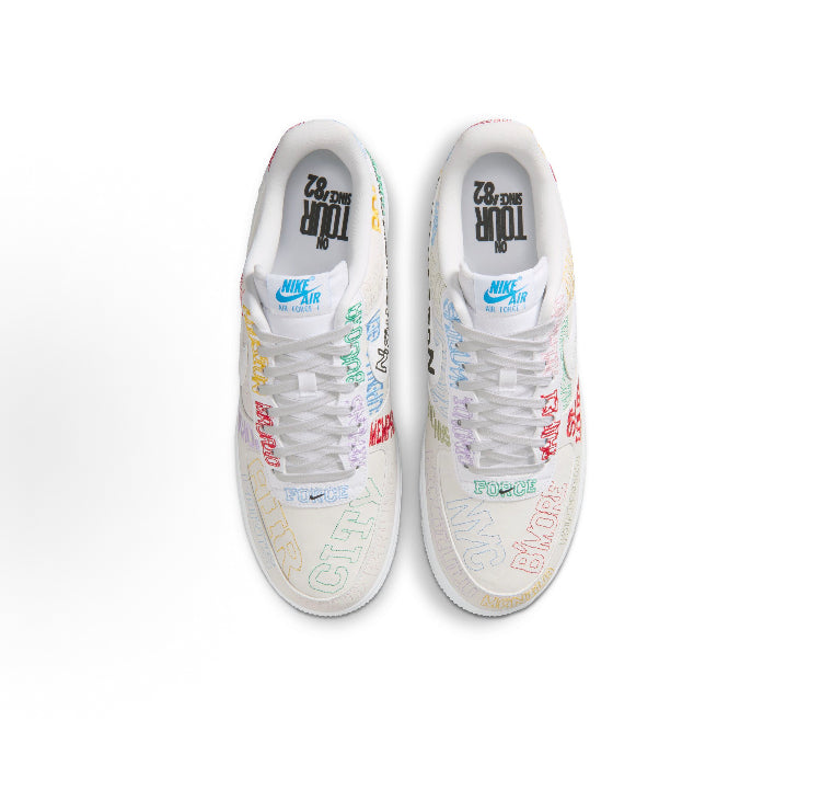 Pair of low-top sneakers shown from the back, beige uppers with multicolor details