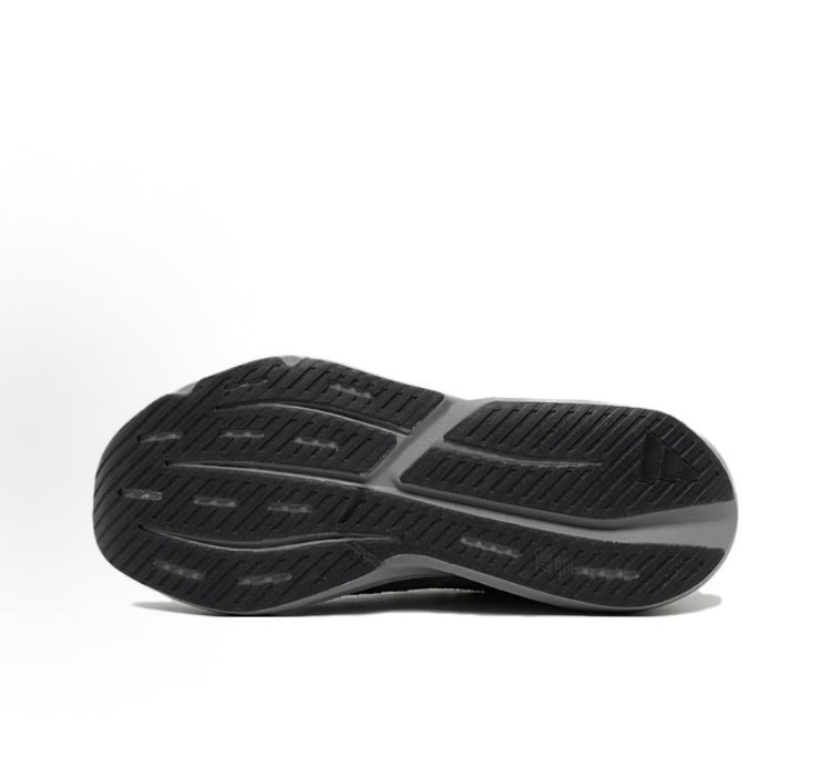 Black and gray running shoe outsole tread with ridged pattern and heel cup
