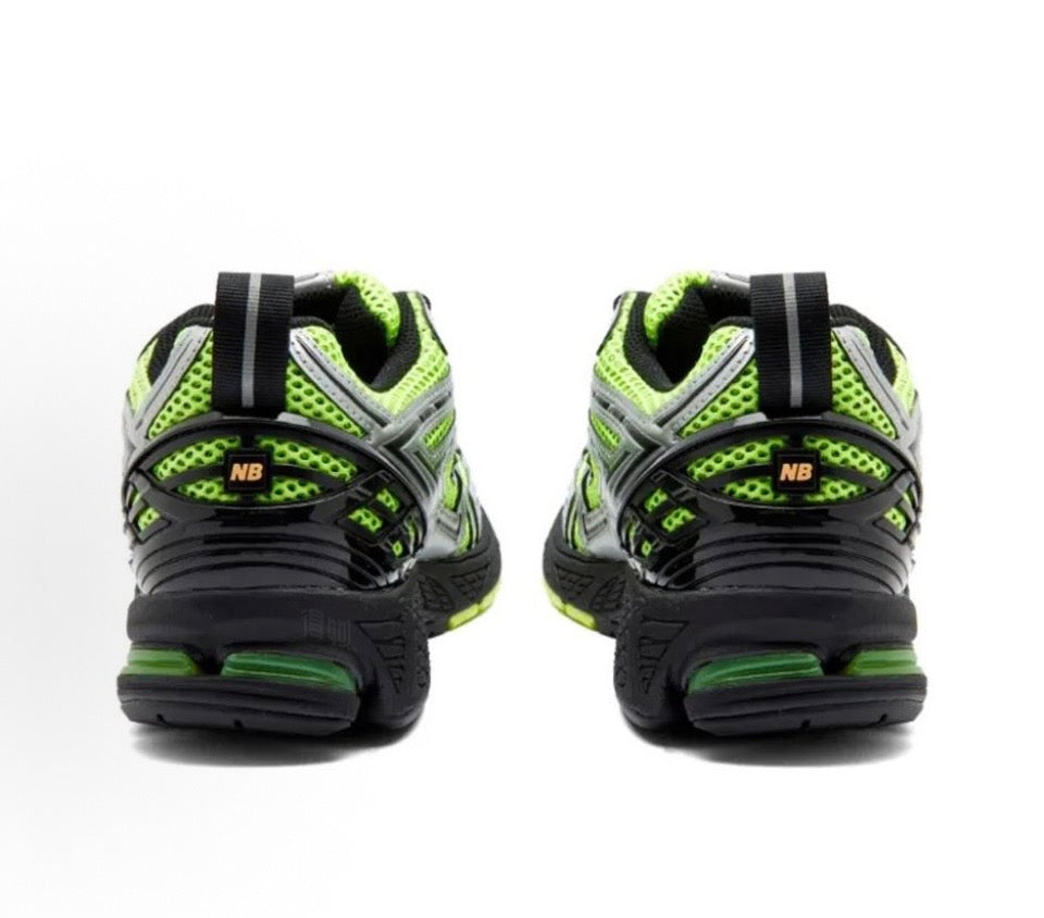 New Balance 1906R sneakers in black with neon green heel and side accents