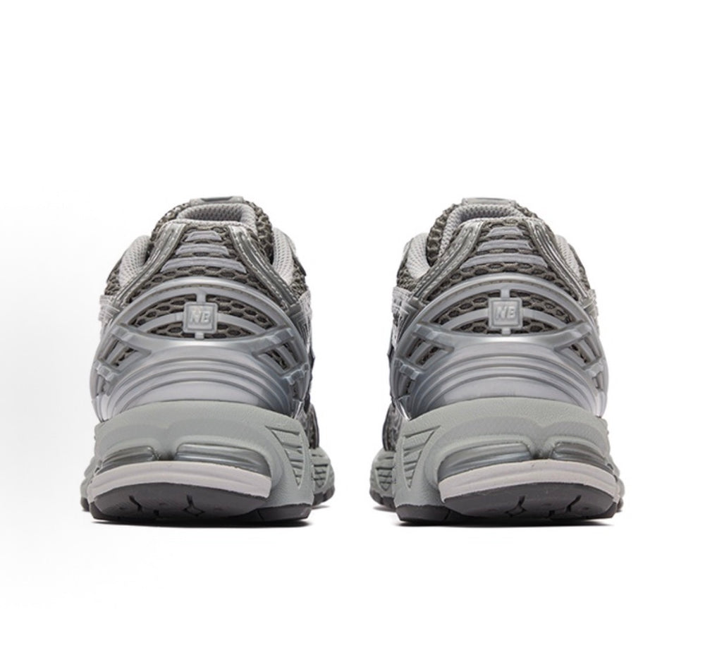 New Balance 1906R sneakers rear view, lace-up gray mesh with cushioned heel pods.
