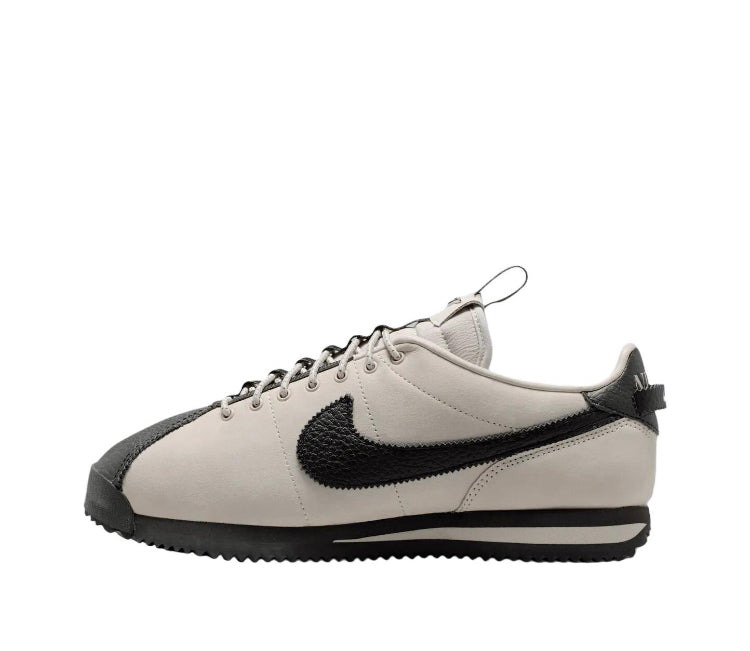 Nike Cortez low-top sneakers, cream uppers with black swoosh and black side stripes
