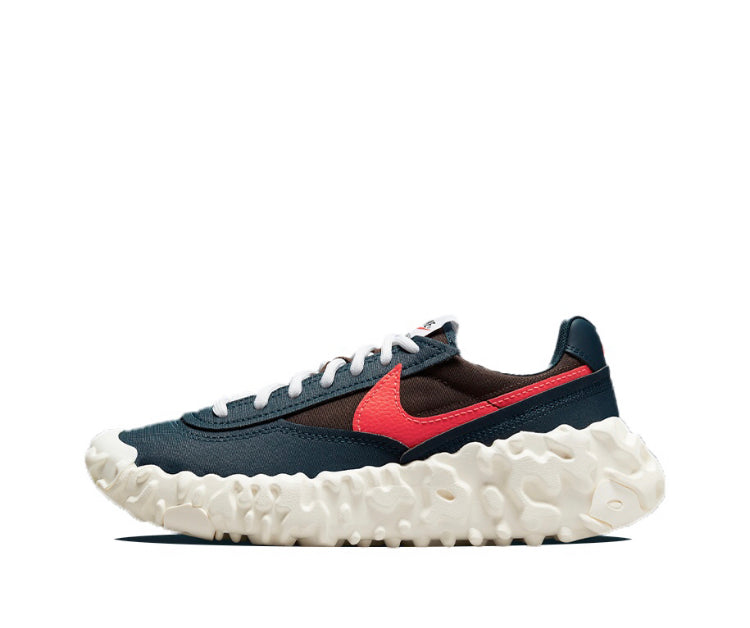 Overbreak sneakers in dark navy with red swoosh and white textured sole, side view