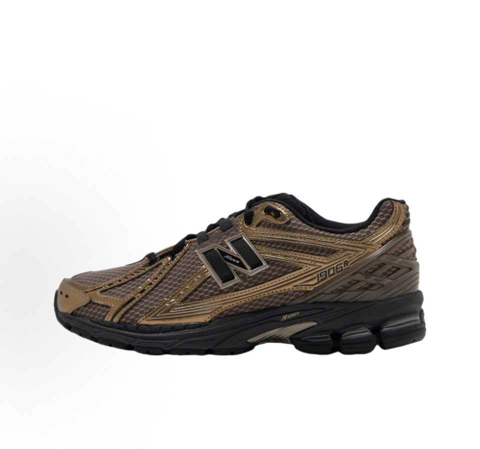 New Balance 1906R sneakers side view, tan mesh with black sole and lace-up N