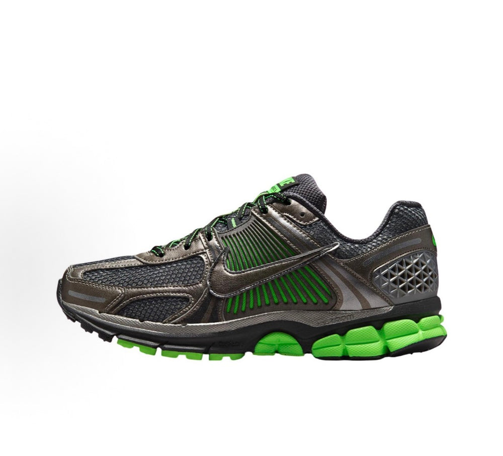 Nike Zoom Vomero 5 side view in dark gray with green swoosh, laces, and cushioned sole