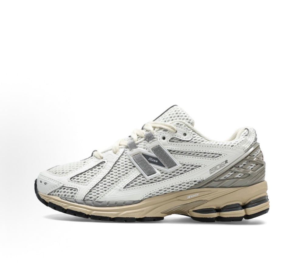 Side view low-top running sneakers in white with gray New Balance logo and beige sole