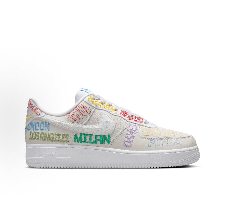 Low-top sneakers with beige upper and multicolor city-style lettering, white sole
