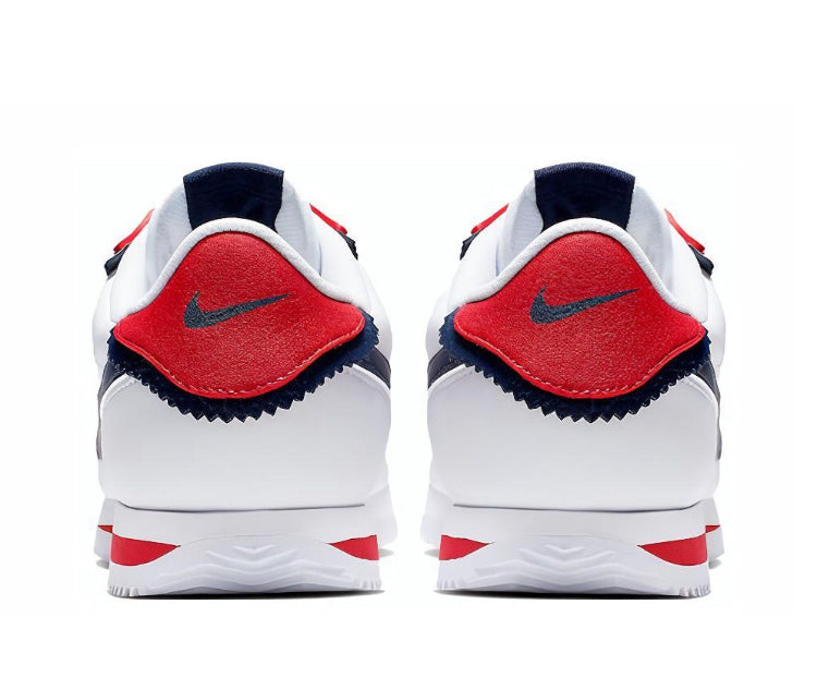 Low-top sneakers with red heel patches, navy lining, and white midsole