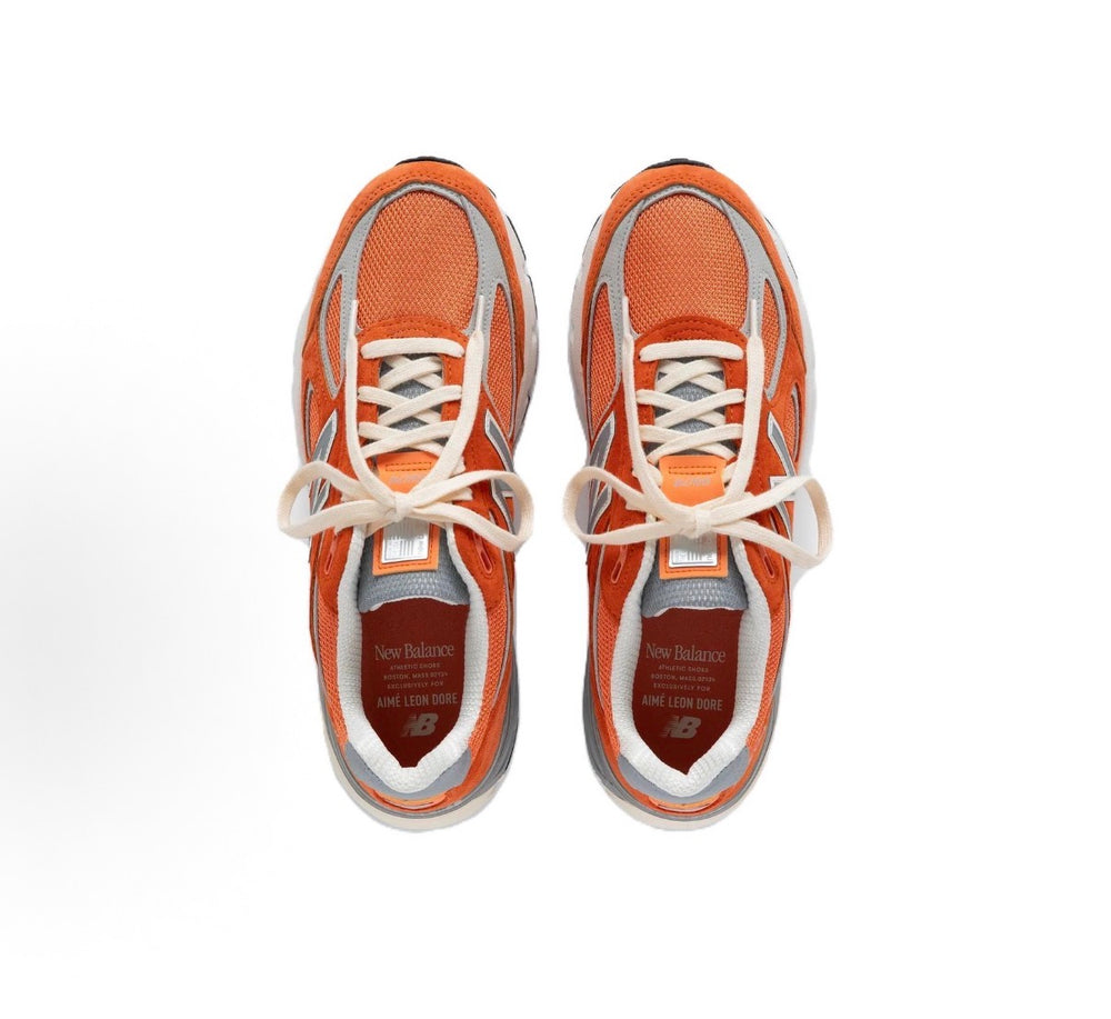New Balance 990 sneakers top view, orange mesh with white laces and gray trim