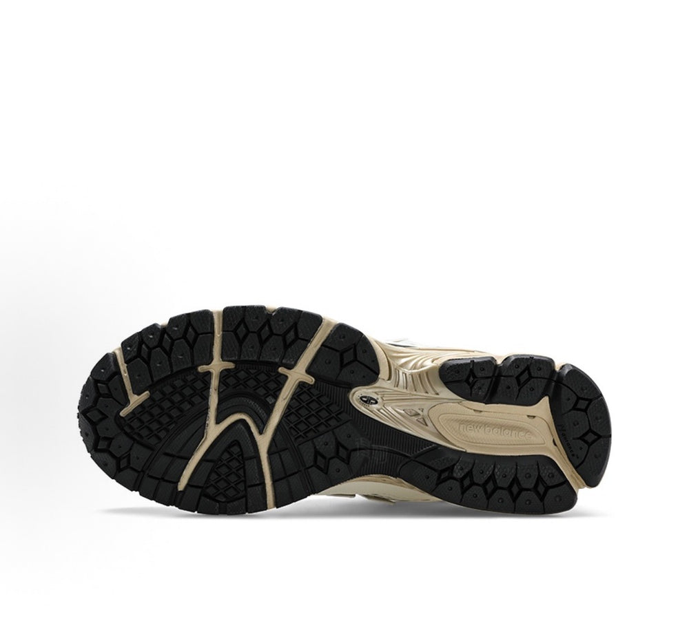 Low-top sneaker outsole with black tread and beige midsole accents for grip