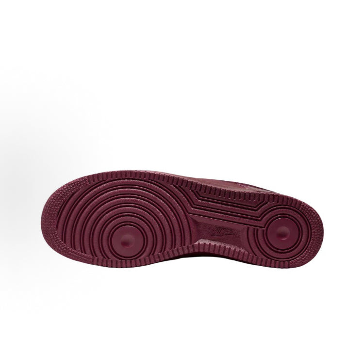 Dark maroon rubber outsole with circular tread pattern for low-top Nike sneakers