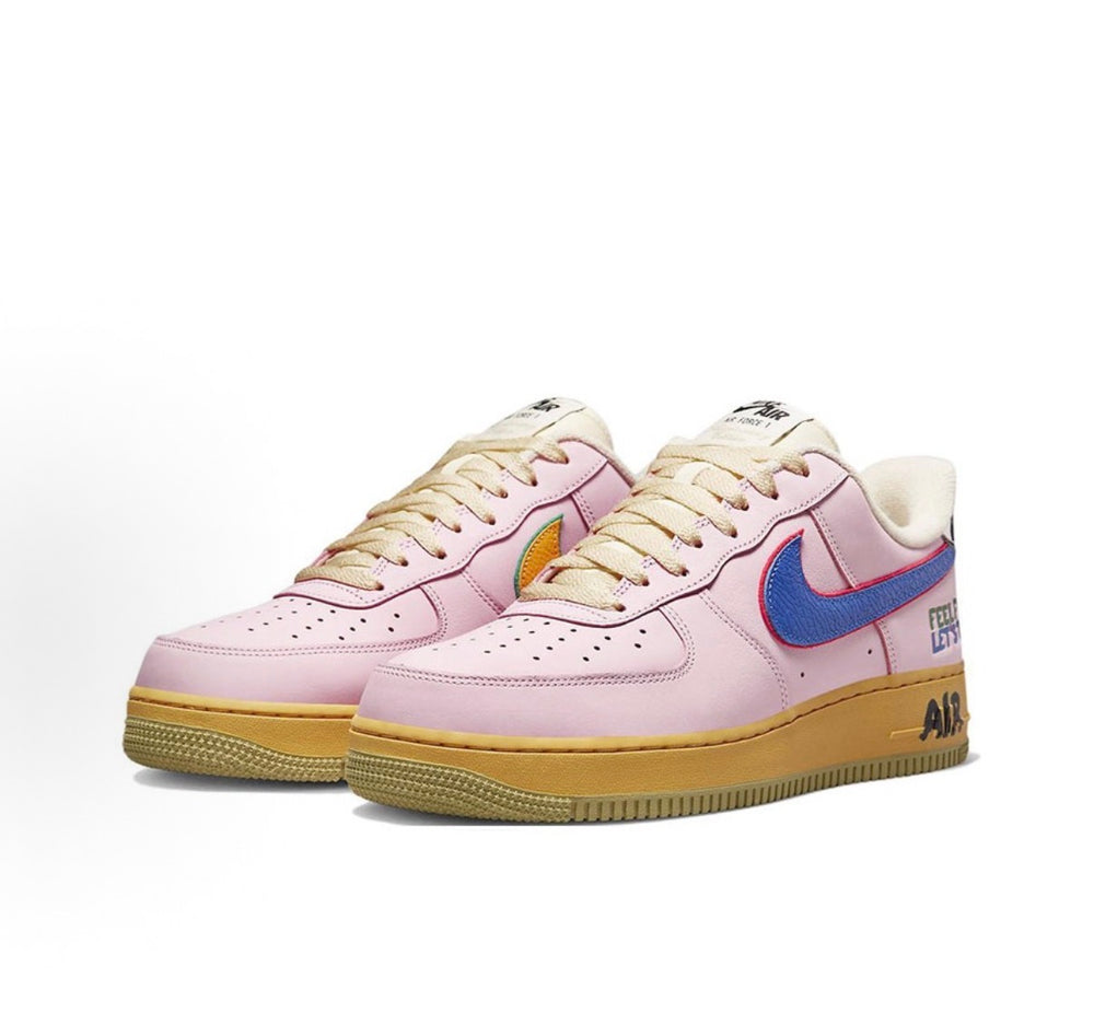 Low-top sneakers with pink leather, blue swoosh, tan gum sole, lace-up styling