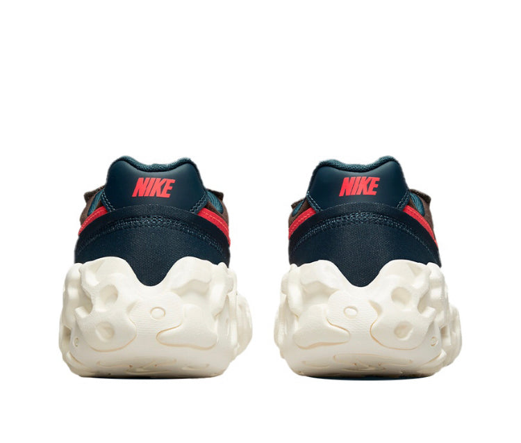 Overbreak sneakers back view with dark navy heels, red details, and white foam sole