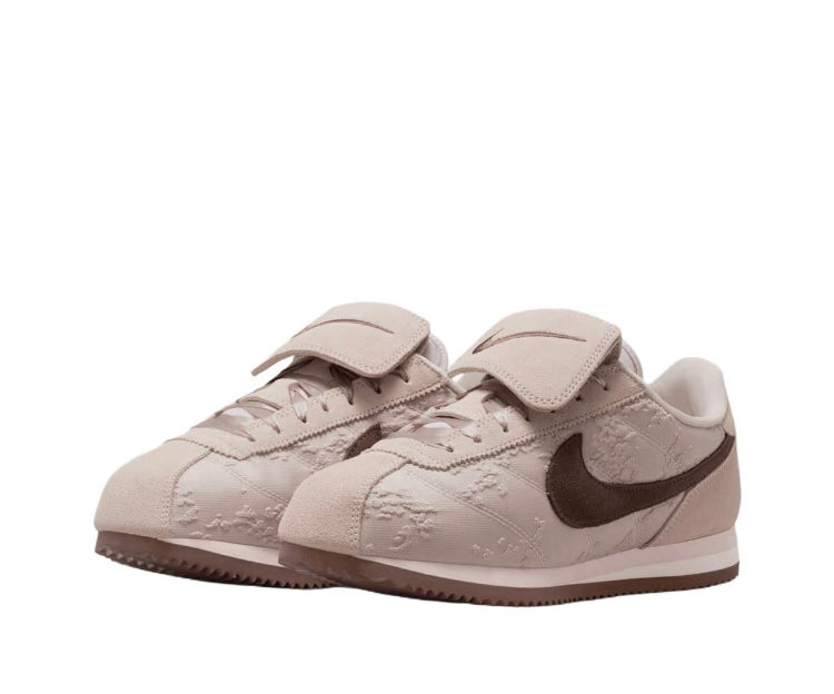 Nike Cortez low-top sneakers, light beige upper with dark brown Swoosh and strap