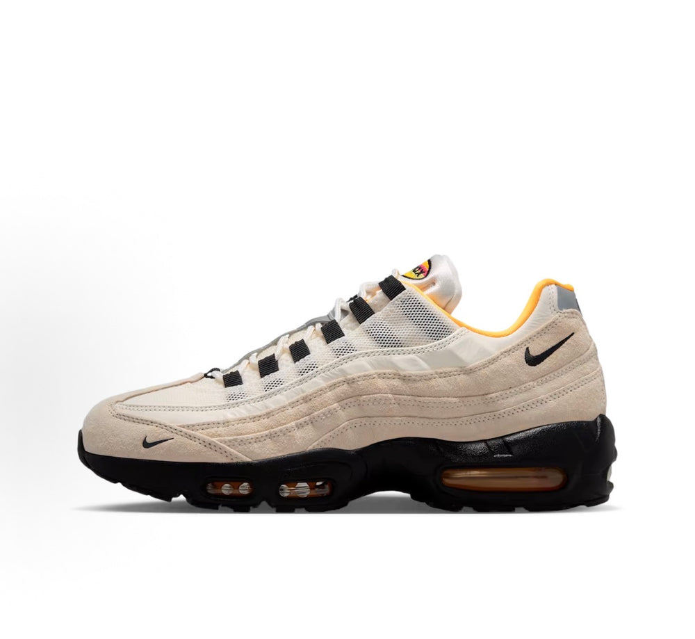 Nike Air Max 95 sneaker side view, beige mesh panels with black sole and orange pods