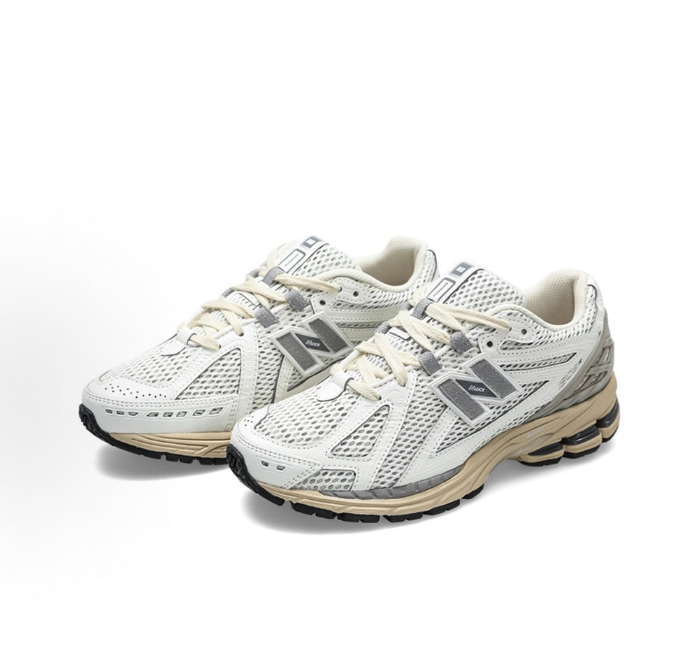 Pair of white low-top running sneakers with gray accents and beige rubber sole