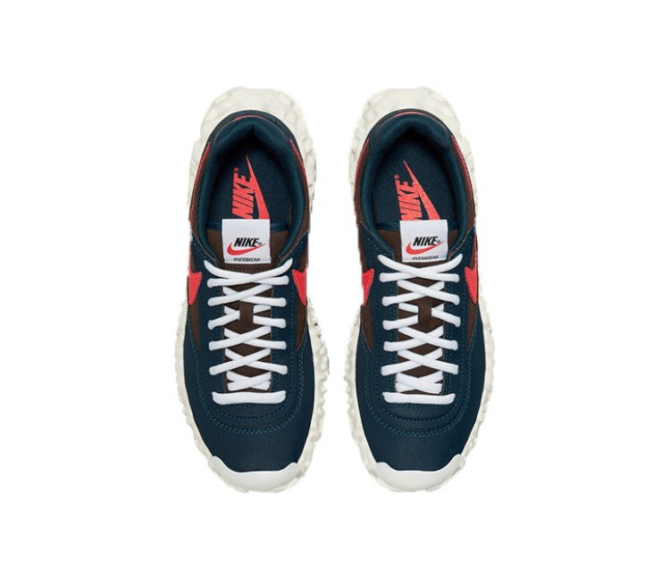 Overbreak sneakers pair with navy uppers, red accents, white laces, thick textured sole