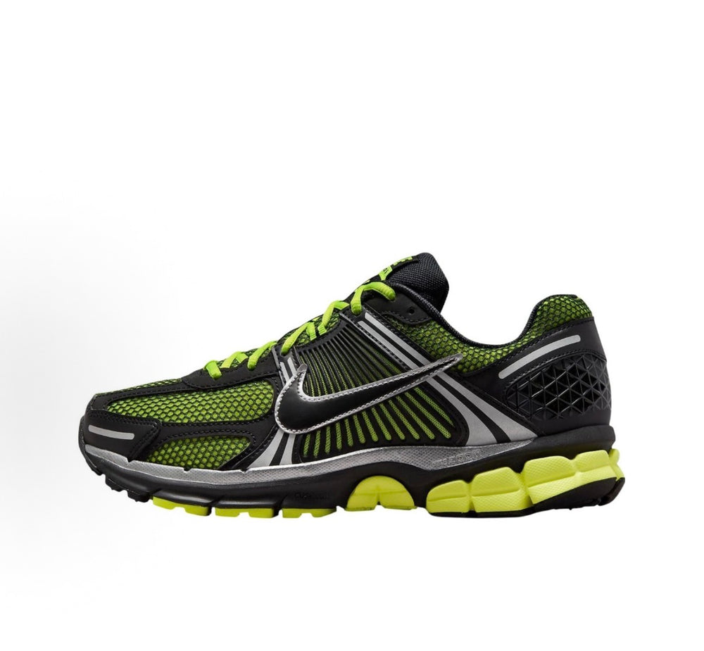 Nike Zoom Vomero 5 sneakers, angled side view: black, neon green, and silver swoosh