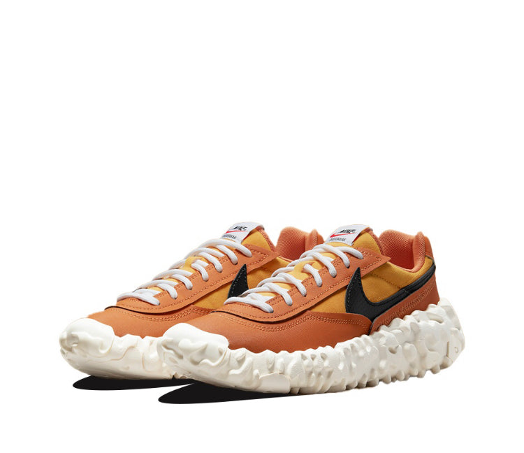 Orange low-top sneakers with black swoosh, white textured sole, lace-up.