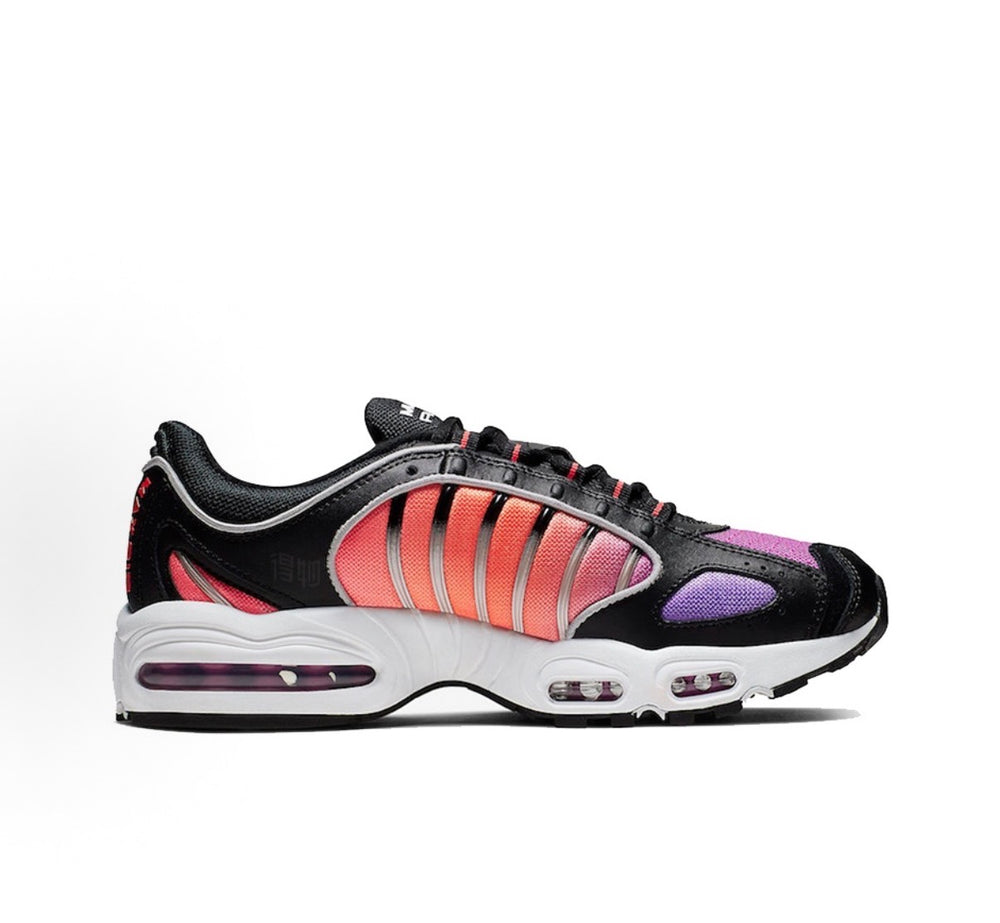 Black, purple and red Nike sneakers with white cushioned sole and lace-up uppers