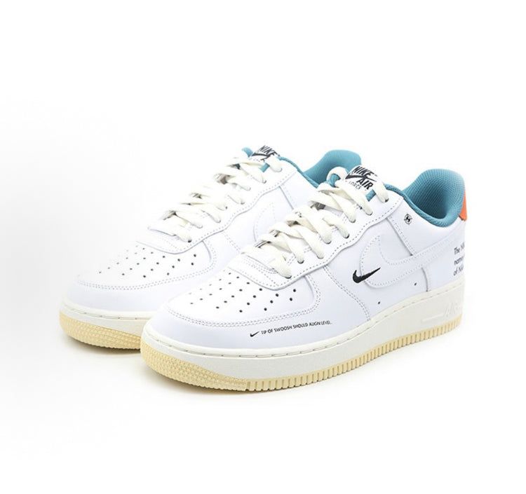 Nike low-top sneakers, white leather uppers with teal collar and orange side accents