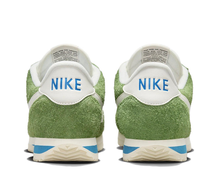 Nike sneakers with green suede heel, blue stripe midsole, and white back tab