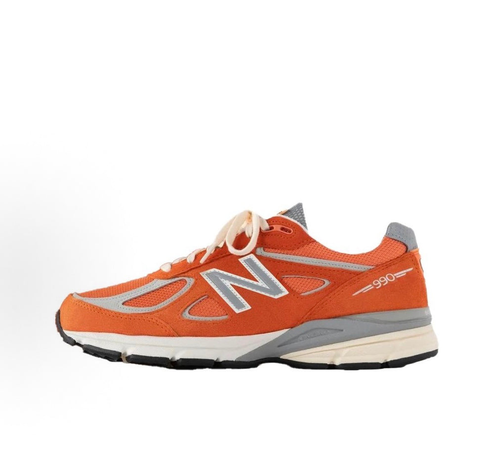 New Balance 990 sneakers 3/4 side, orange upper with gray accents and white laces