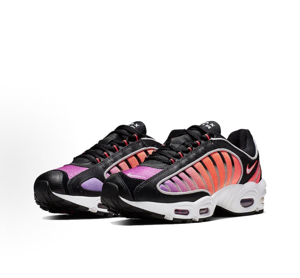 Black Nike sneakers with purple and red stripe panels, white midsole, and lace-up