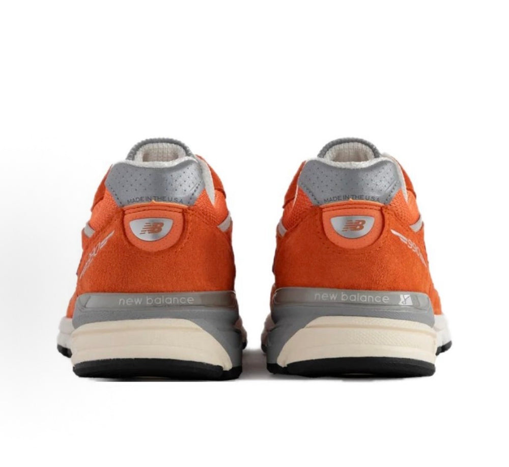 New Balance 990 sneakers heel view, orange suede with gray collar and branding