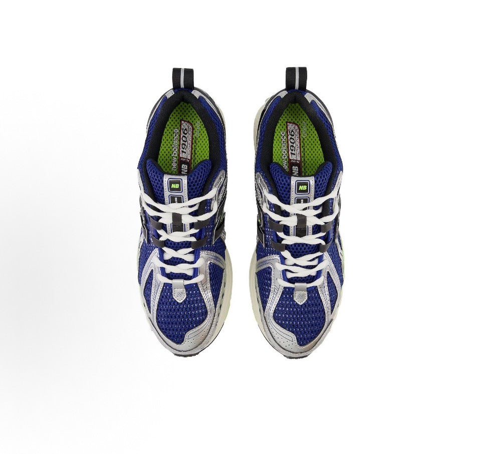 Blue and white laced sneakers with back branding and neon green midsole