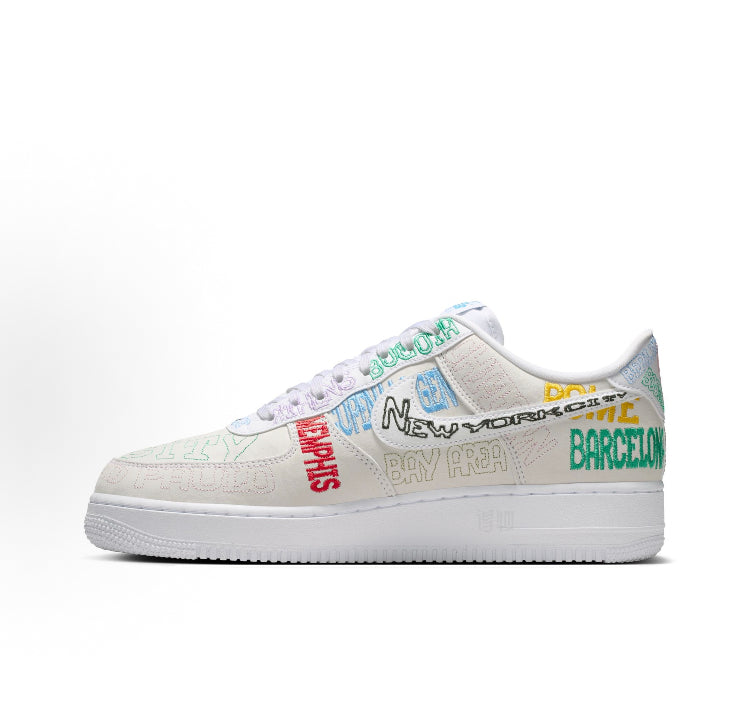 Low-top sneakers with beige upper, multicolor side lettering, white laces and sole
