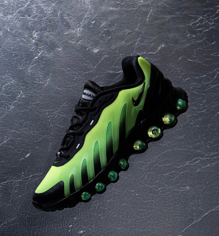 Nike Air Max Dn8 close-up shoe angle, black laces and neon green upper with green outsole pods