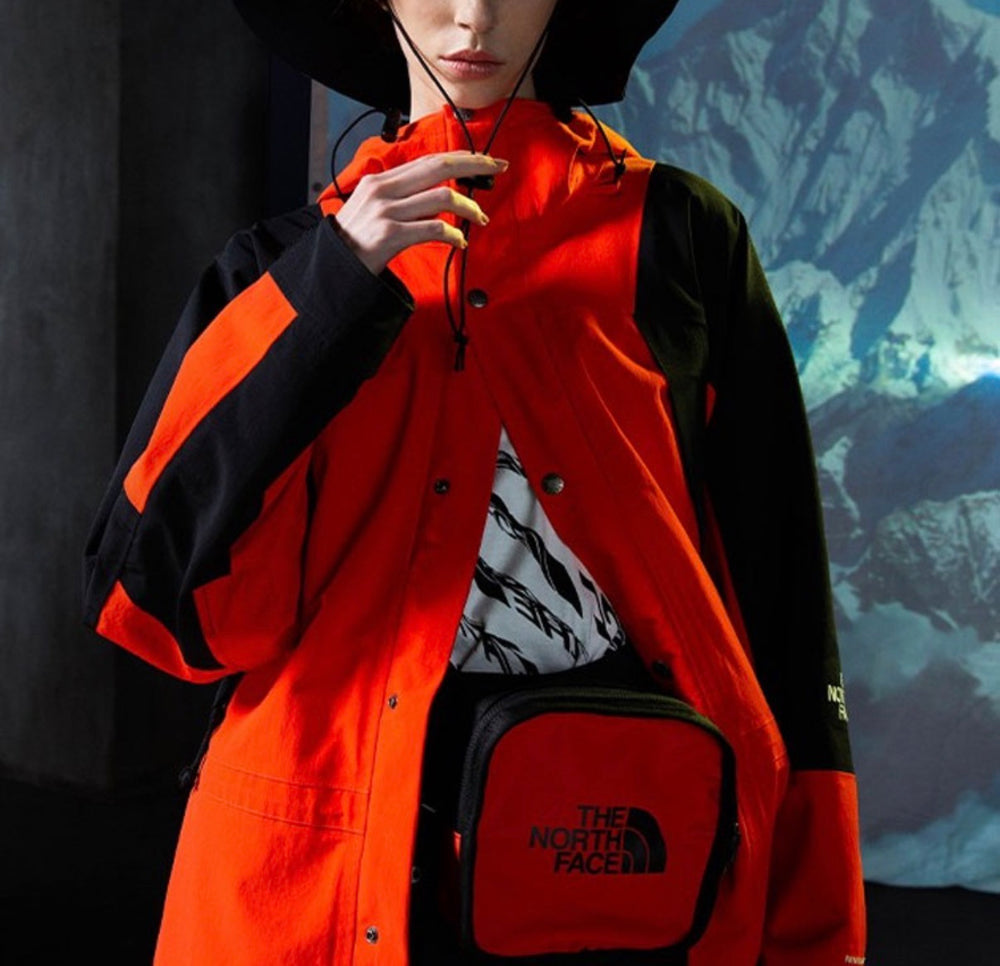 Orange and black hooded jacket with drawcord hood, front snaps, zip pocket