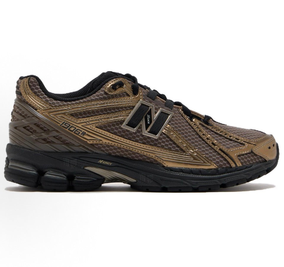 New Balance 1906R sneakers side profile, tan with black outsole, lace-up N logo
