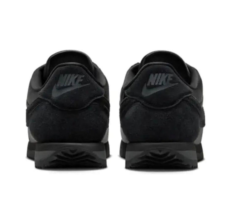 Nike Cortez sneakers in black, heel view with Nike logo on the back