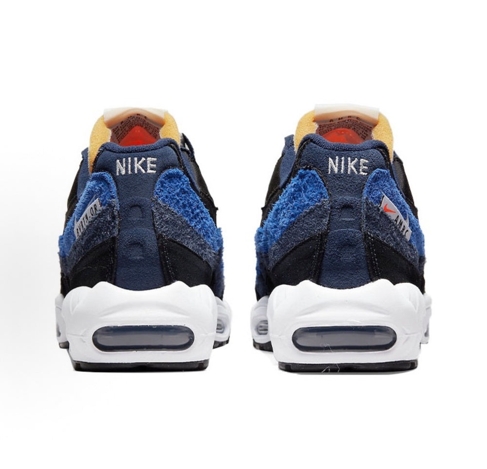 Nike Air Max 95 sneakers, navy and black uppers with blue heel panel and white soles.