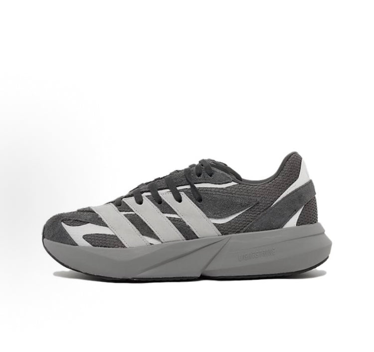 Carbon gray Adidas running shoes with white three-stripe overlays and chunky light sole