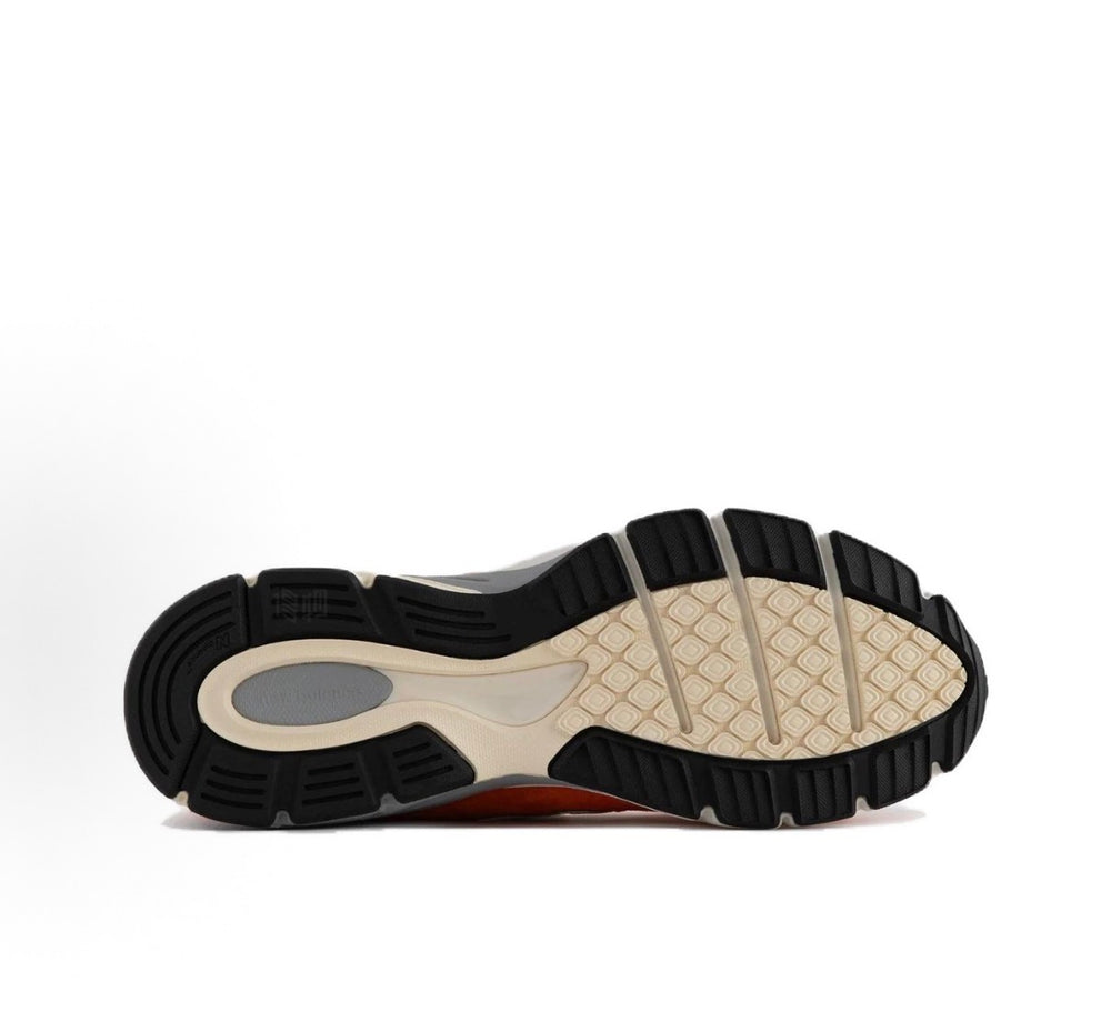 New Balance 990 shoe outsole view with dark rubber tread and cream midfoot