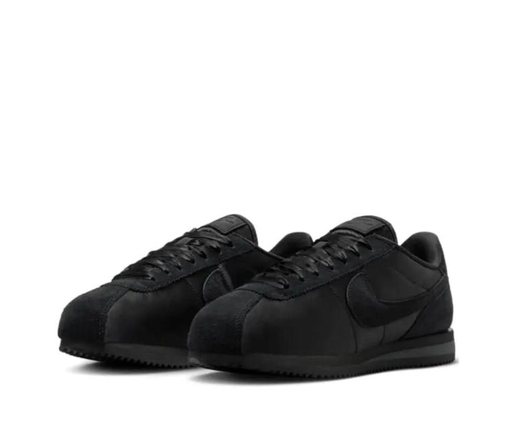 Nike Cortez low sneakers in black, front angle with Swoosh and laces