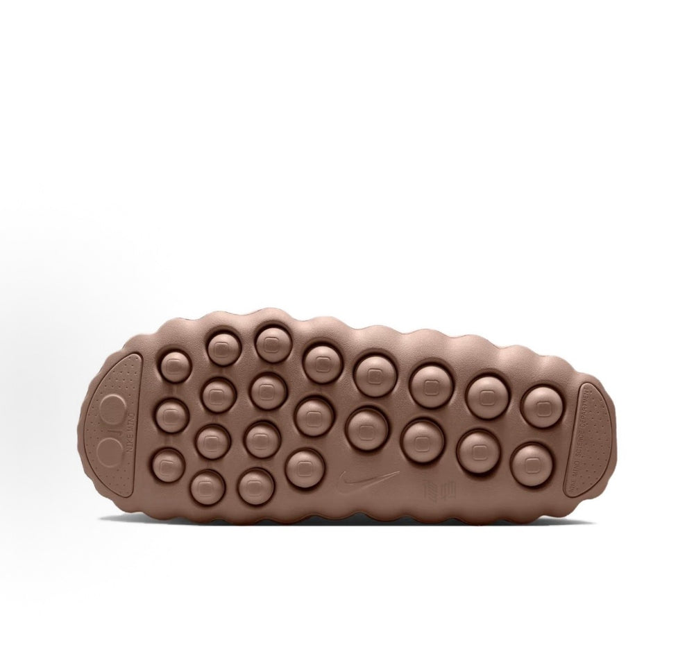 Nike slide sandal outsole view in taupe with circular traction pods