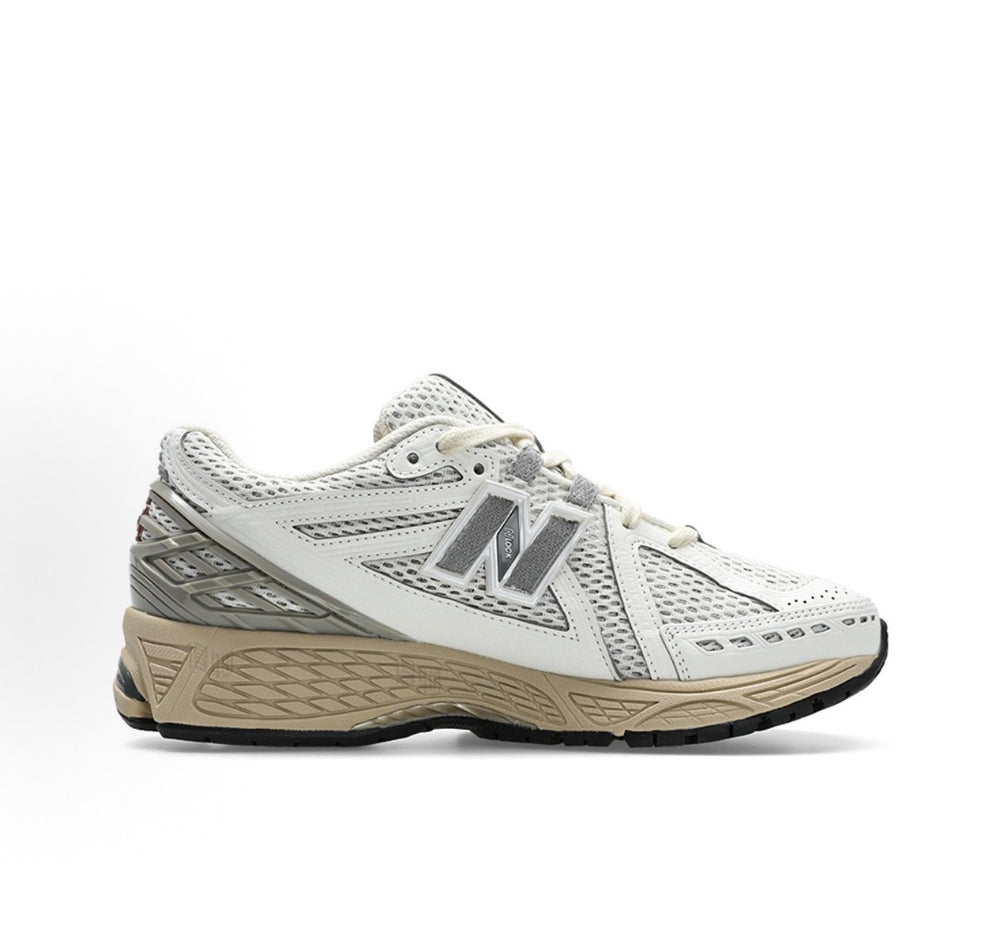 White low-top running sneakers with gray New Balance logo and beige outsole