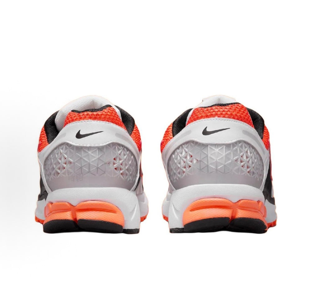 Nike Zoom Vomero 5 SP running shoe heel view with orange accent and black collar.