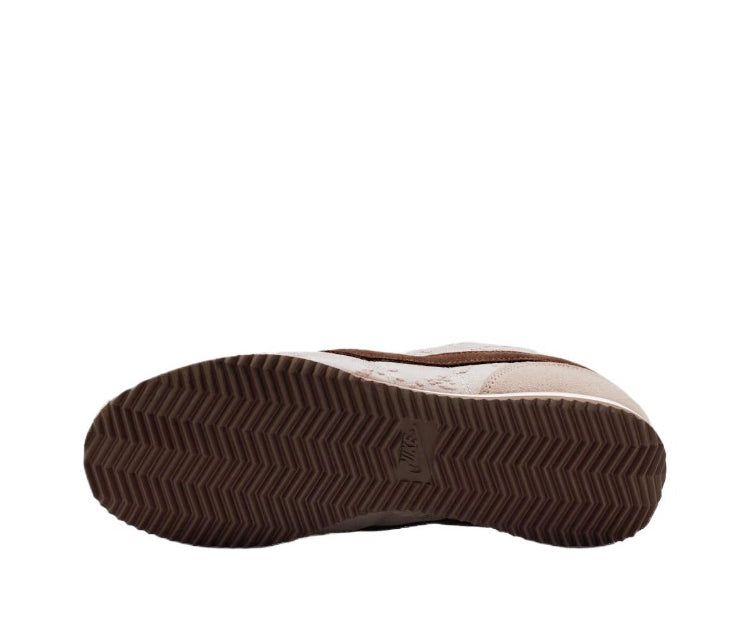 Nike Cortez outsole view, textured dark brown rubber sole on beige shoe