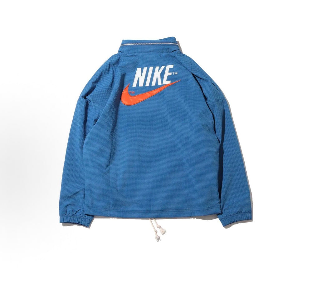Nike woven hooded jacket back view in dark blue with Nike logo