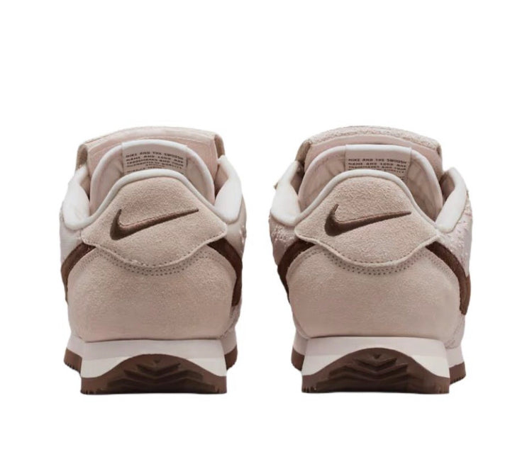 Nike Cortez low-top sneakers, light beige back view with dark brown heel detail