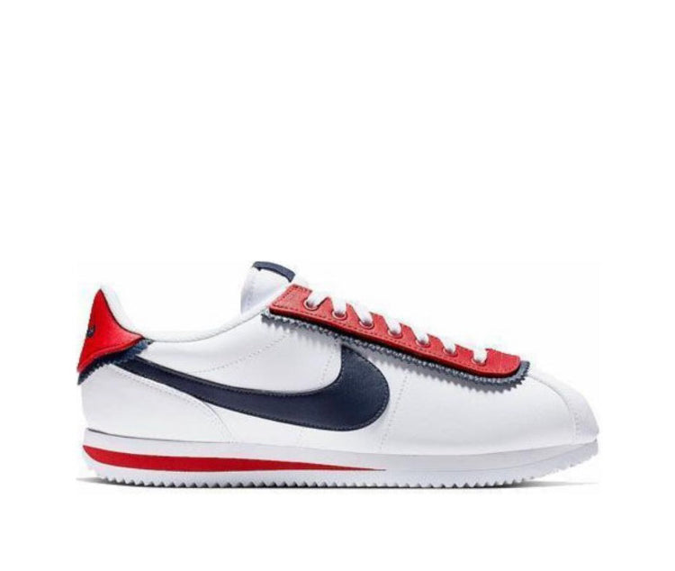 Low-top sneaker side view with white leather, red stripe, and navy Swoosh